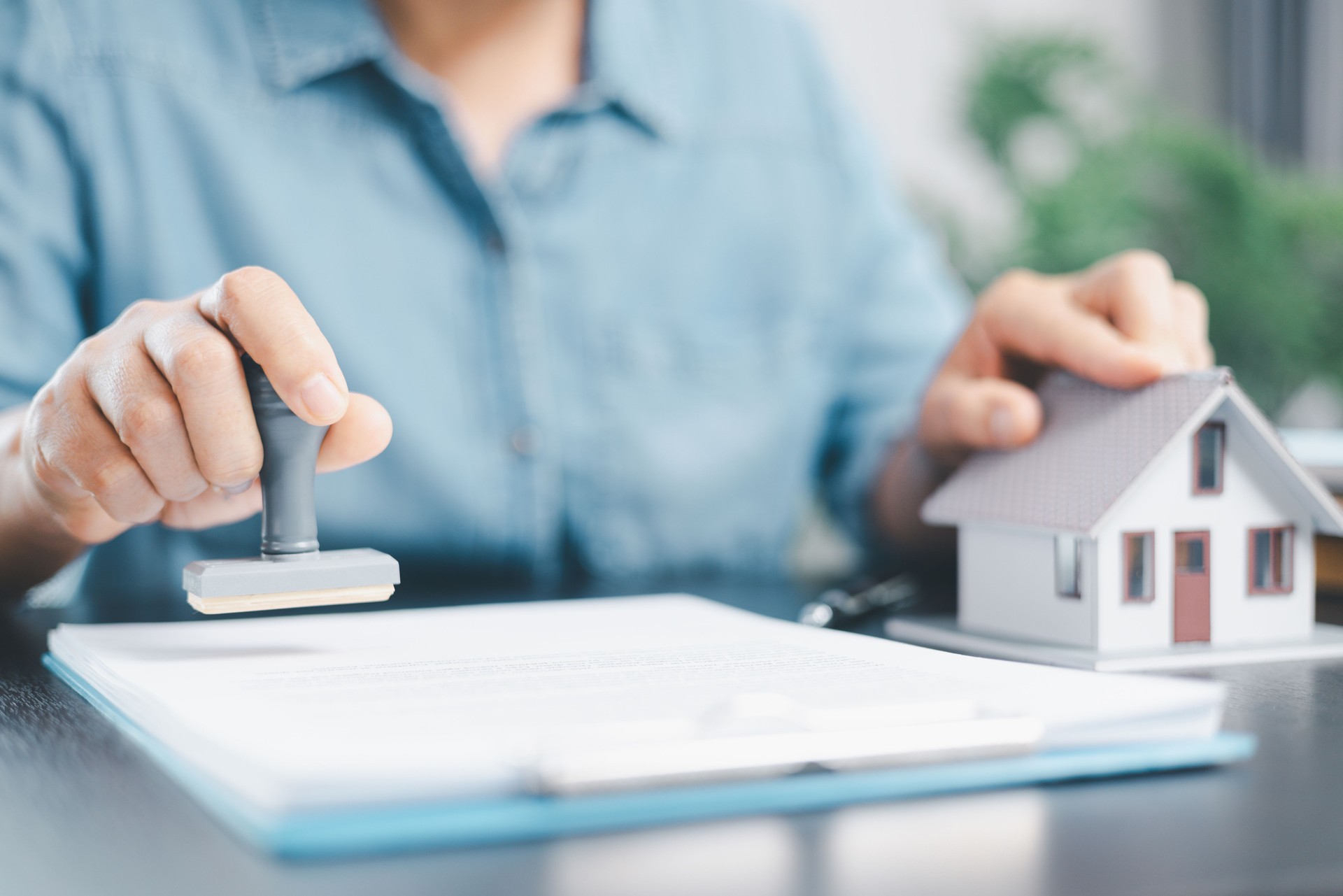Businesswoman hand stamp approve on financial business approval document paper. Man hand accept permit contract agreement. Broker manager sign contract bank guarantee approved stamp application form